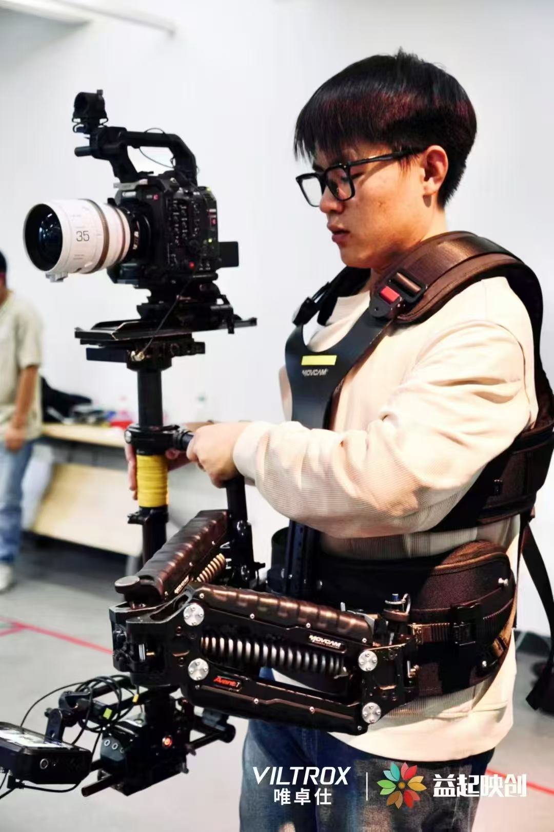 Linrui Hu operating a cinema camera on a body-mounted stabiliser